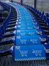 A row of blue shopping carts in front of Aldi food store.